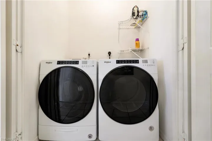 Washroom with washer and clothes dryer