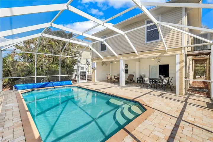 View of swimming pool with a patio area and a lanai
