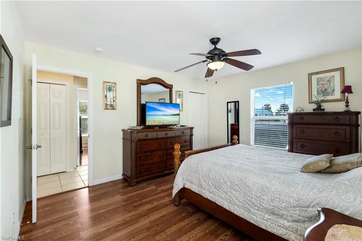 Bedroom featuring ceiling fan and dark wood-type flooring