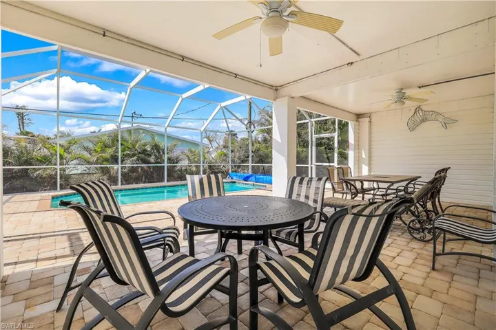 View of patio / terrace featuring ceiling fan and glass enclosure