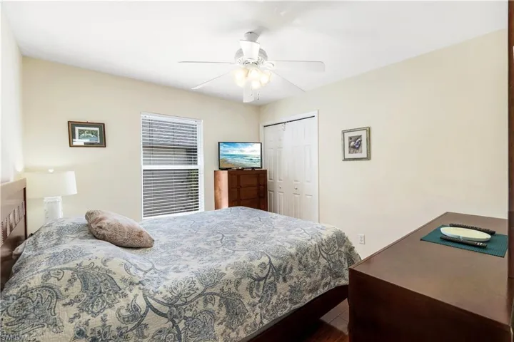 Bedroom featuring hardwood / wood-style floors, ceiling fan, and a closet