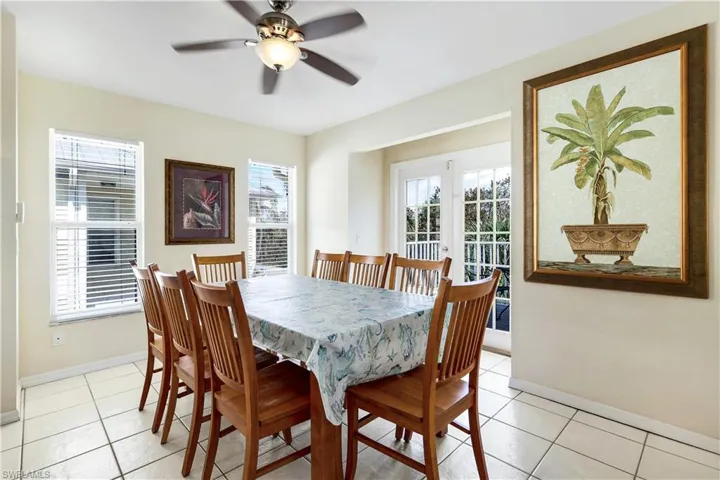 Tiled dining room with ceiling fan