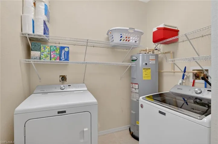 Spacious laundry room with additional storage closet