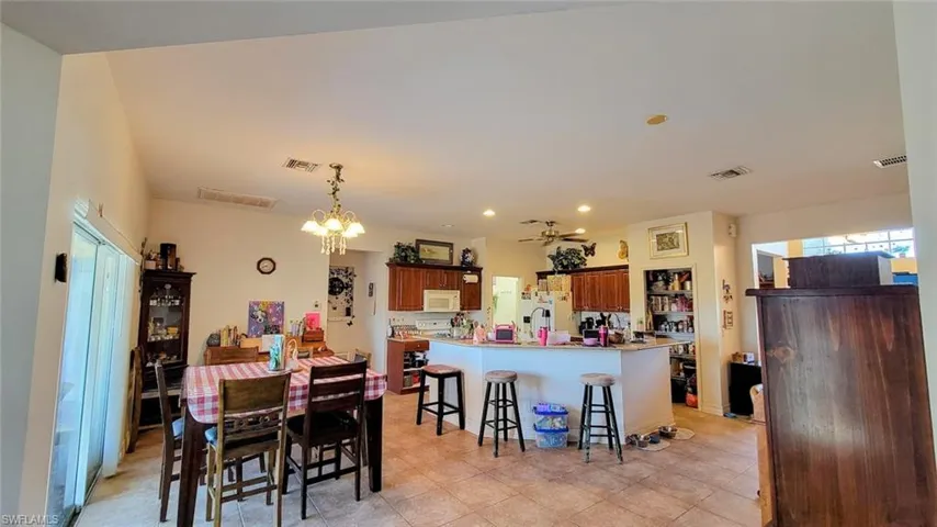 Dining area with ceiling fan and a chandelier