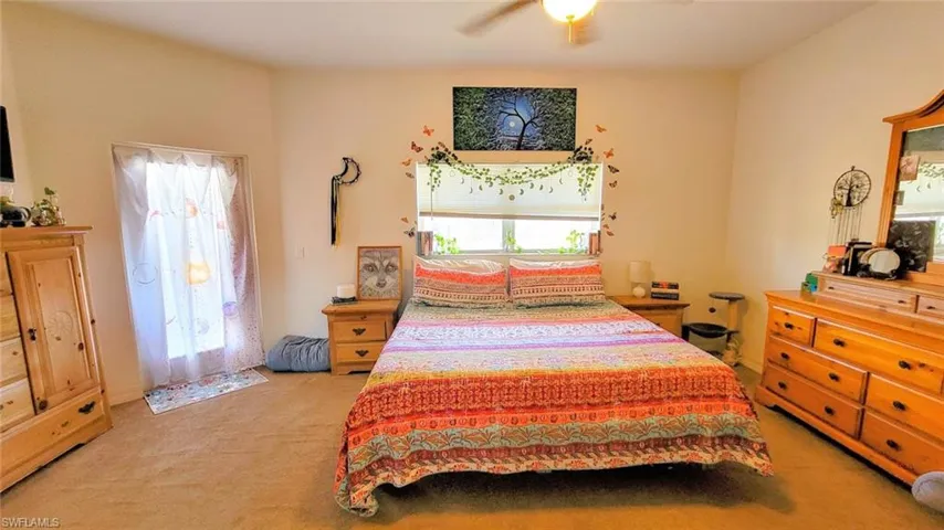 Bedroom featuring light colored carpet and ceiling fan