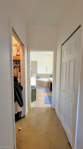 Hall featuring light carpet