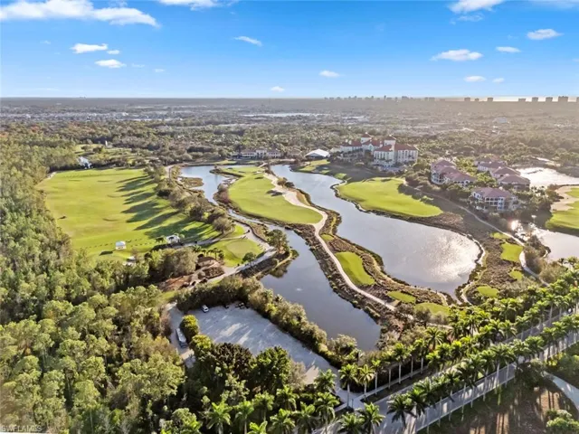 Aerial view of residential area with a local golf course and a nearby body of water