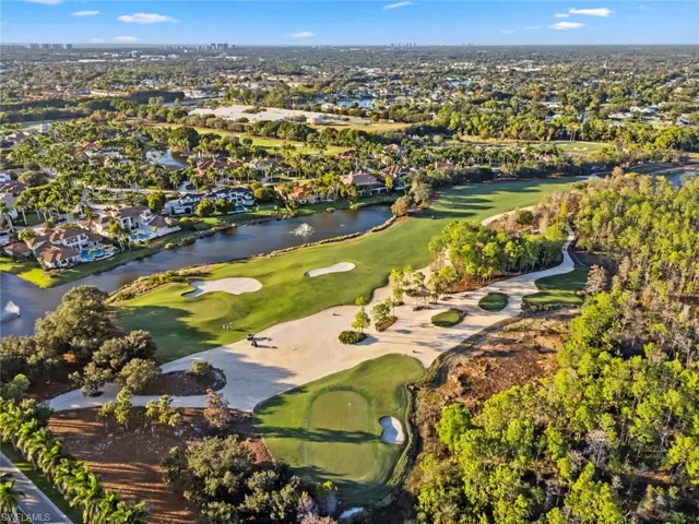 Aerial view of property's location with nearby suburban area and a nearby body of water
