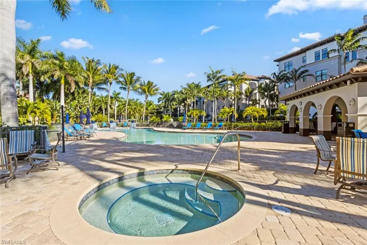 Community pool featuring a hot tub and a patio