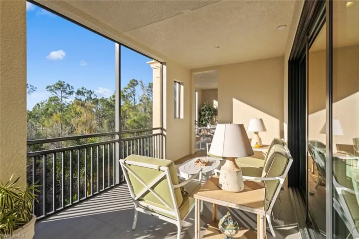 Balcony featuring a sunroom