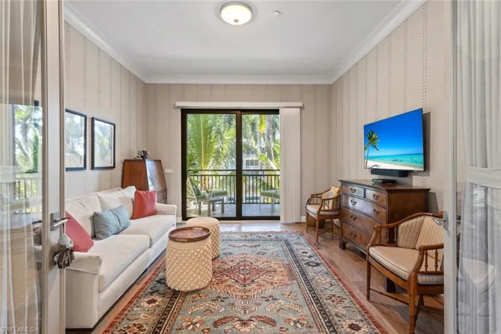 Living area featuring ornamental molding and wood finished floors