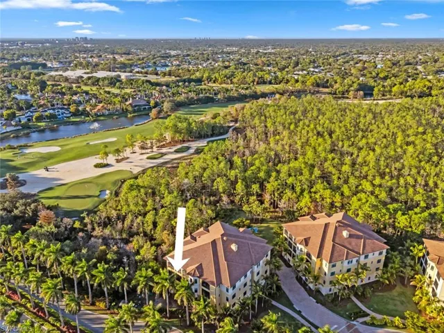 Drone / aerial view of a golf club and a nearby body of water