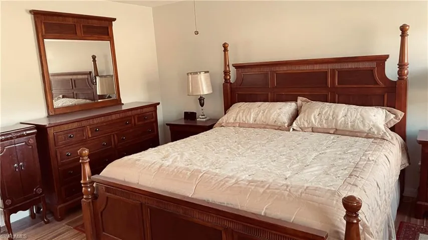 Bedroom with dark wood-type flooring
