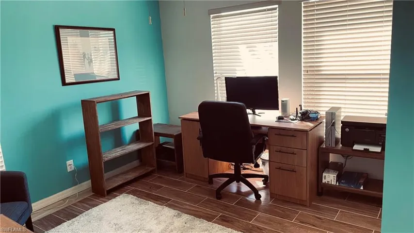 Office featuring wood finish floors and baseboards