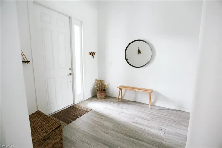 Foyer featuring wood finished floors and baseboards
