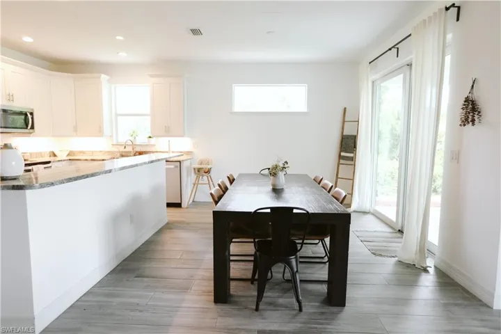 Dining space featuring plenty of natural light, recessed lighting, and light wood-style flooring