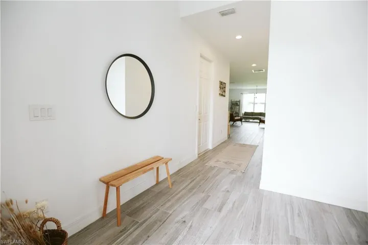 Corridor featuring light wood-style floors, recessed lighting, and baseboards