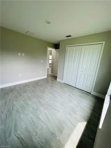 Unfurnished bedroom with a closet