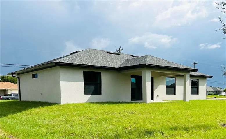 Rear view of property with a yard