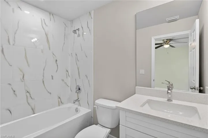 Bathroom featuring vanity and  shower combination