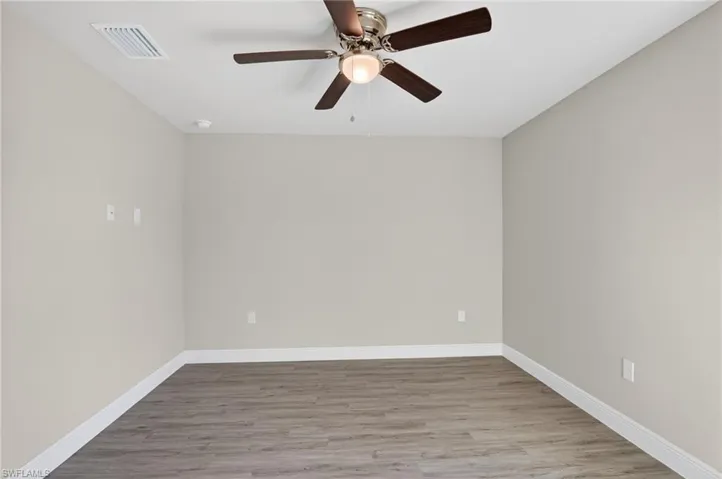 Empty room with light wood-type flooring and a ceiling fan