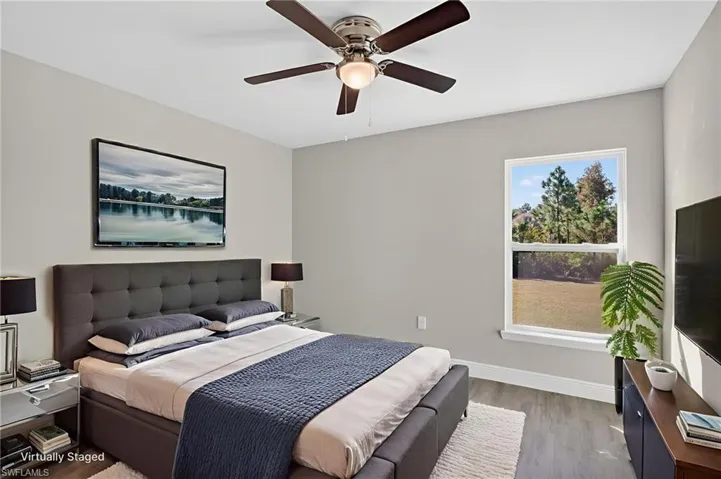 Bedroom featuring wood finished floors and a ceiling fan
