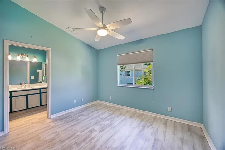 Unfurnished bedroom with hardwood / wood-style flooring, a towering ceiling, a closet, and ceiling fan