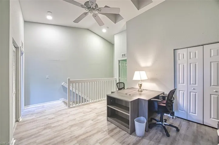 Unfurnished bedroom featuring sink, ensuite bathroom, ceiling fan, and light wood-type flooring