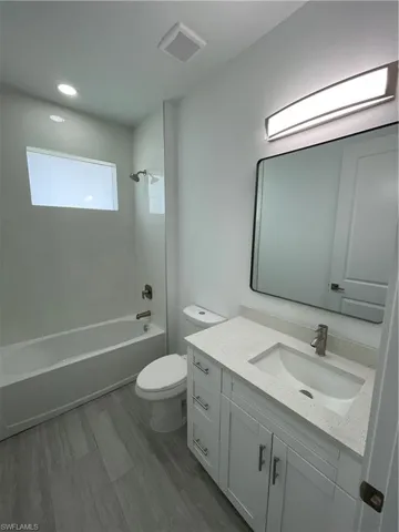 Full bathroom featuring bathing tub / shower combination, vanity, and recessed lighting
