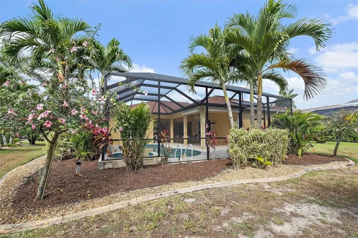 Pool featuring glass enclosure and a patio area