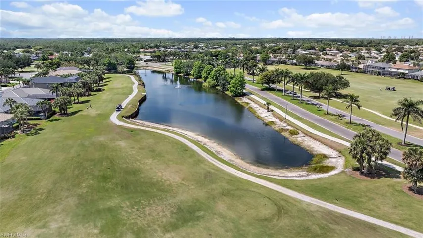 Aerial view featuring a residential view, a water view, and golf course view