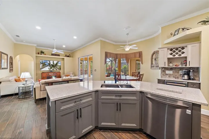 Kitchen with a ceiling fan, gray cabinets, a sink, and dishwasher
