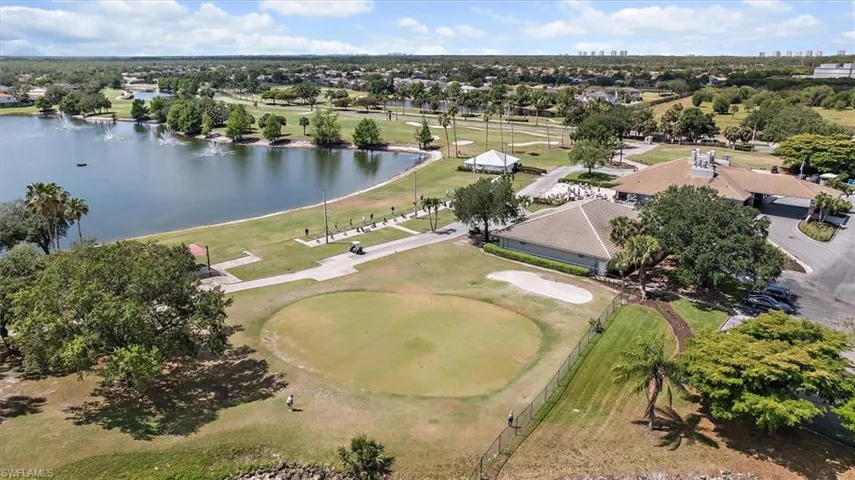 Drone / aerial view featuring a water view, view of golf course, and a residential view