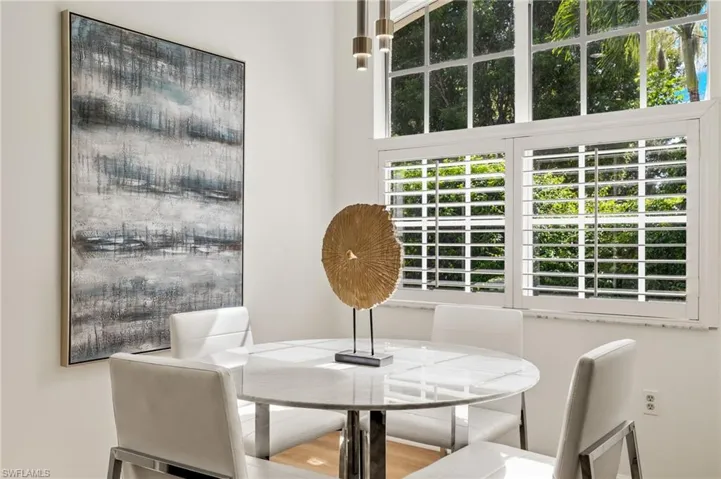 Kitchen featuring stainless steel appliances, LVP flooring, backsplash, and quartz counters