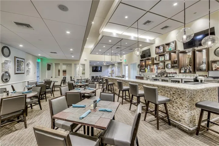 Carpeted dining area featuring a drop ceiling