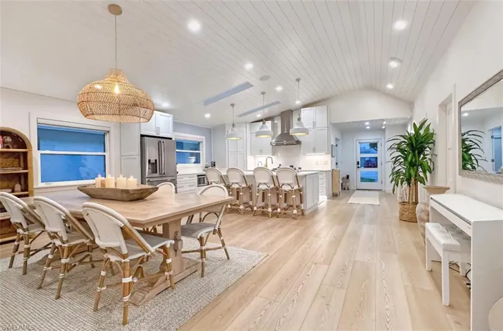 Dining area featuring light wood-style floors, a vaulted wooden ceiling, and recessed lighting