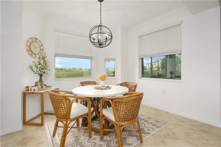 Dining room with a chandelier, crown molding, and baseboards