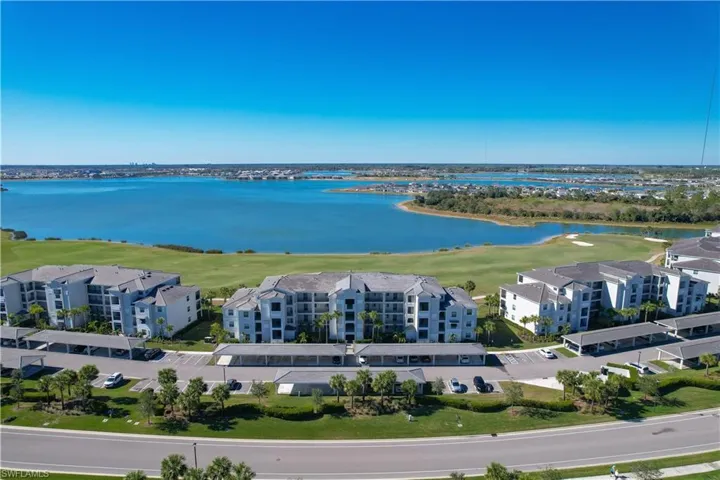 Birds eye view of property with a water view