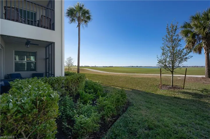 View of yard with a balcony and a ceiling fan