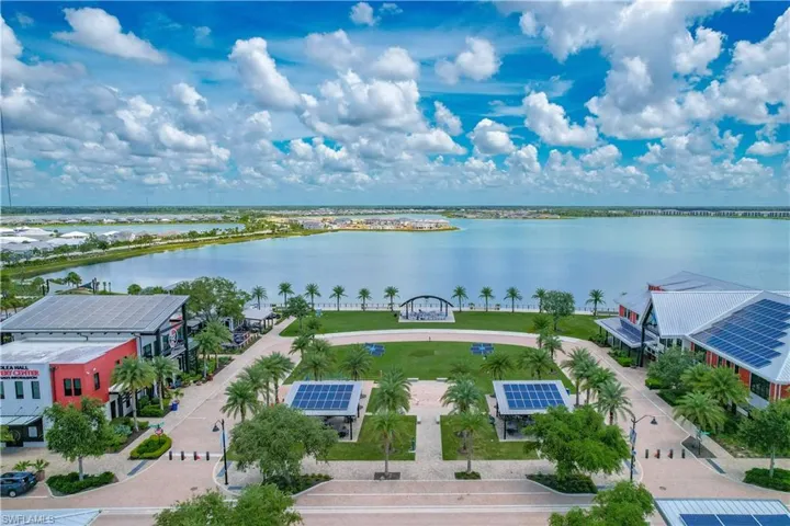Birds eye view of property with a water view