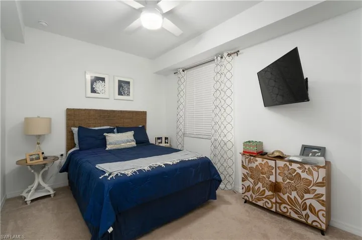 Bedroom with carpet flooring, ceiling fan, and baseboards