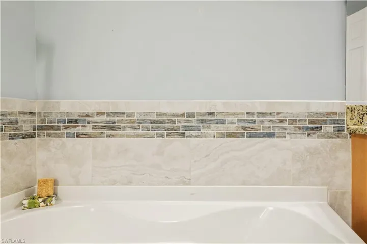 Full bathroom featuring a bath