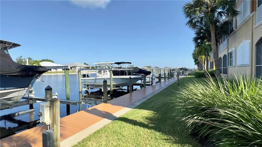 Dock area featuring a yard and a water view