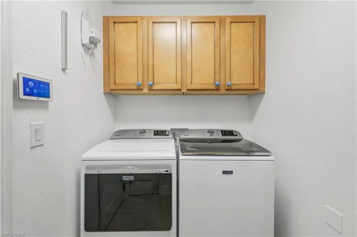 Laundry area featuring cabinet space and separate washer and dryer