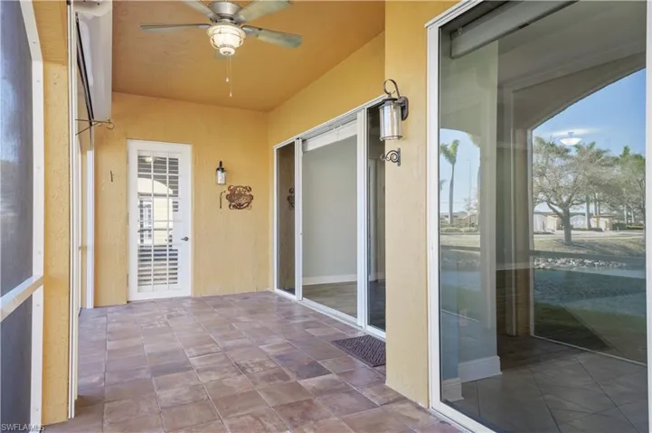 Unfurnished sunroom featuring a ceiling fan