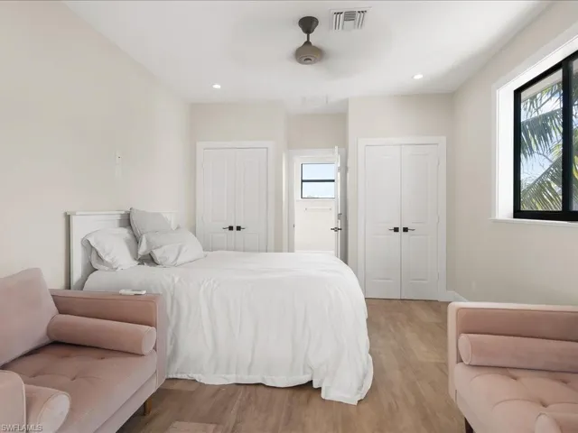 Bedroom featuring multiple closets, light wood finished floors, ceiling fan, and recessed lighting