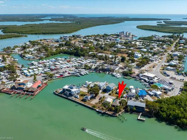 Aerial view of property and surrounding area featuring a nearby body of water