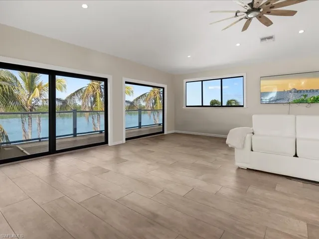 Living room with a ceiling fan, recessed lighting, and wood tiled floors