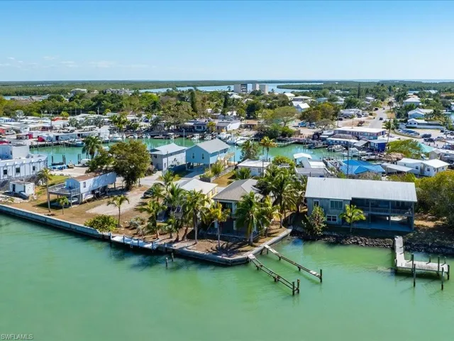 Aerial view of property's location with a large body of water