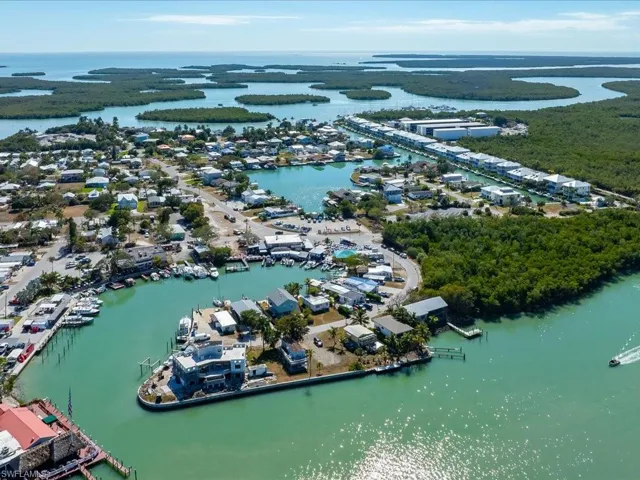 Aerial view of property and surrounding area featuring a nearby body of water